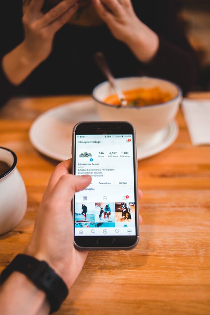 Crafting Captivating Headlines: Your awesome post title goes here From above of crop anonymous male browsing social media on mobile phone while sitting at wooden table with woman eating bright soup in restaurant